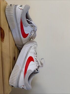Nike White Sneakers with Orange Swoosh and Light Gray Accents
